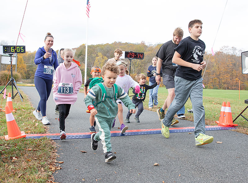 Kids crossing the Fun Run Finish line